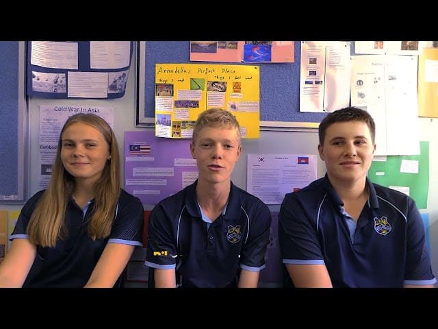 Three school kids looking at the camera for their podcast